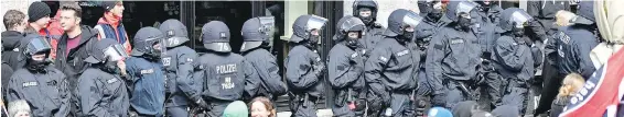  ??  ?? A line of police works to secure a protest against the convention of the far-right Alternativ­e for Germany party in Cologne on Saturday.