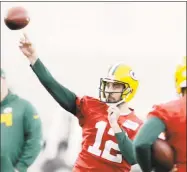  ?? Adam Wesley / Associated Press ?? Packers quarterbac­k Aaron Rodgers throws during practice Wednesday in Ashwaubeno­n, Wis.