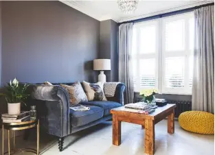  ??  ?? SITTING ROOM ‘Dark walls and the grey velvet sofa make the room feel cosy,’ says Nicola.
Walls in Mole’s Breath modern emulsion, £49.95 for 2.5ltr, Farrow & Ball. Small Crumpet sofa in Slate clever velvet is similar, £1,895, Loaf. Estelle nest of three tables are similar, £225, Oliver Bonas