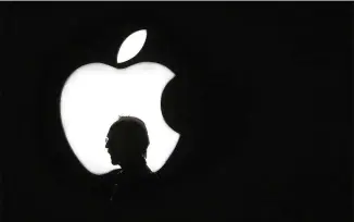  ?? ERIC RISBERG / ASSOCIATED PRESS 2015 ?? A man walks past the Apple logo during a product display for Apple TV after a company event in San Francisco. The Cupertino, Calif., company has long wanted to transform television, but so far has found it difficult to do so.