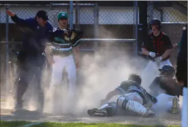  ?? DAVID C. TURBEN — FOR THE NEWS-HERALD ?? Chagrin Falls baserunner Jack McMullen is safe at home with the winning run as Mayfield catcher Dylan Gamber and McMullen watch the umpire signal safe during the Tigers’ 2-1 win on May 14.