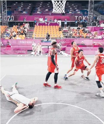  ?? CHRISTIAN PETERSEN/GETTY ?? Japan’s Keisei Tominaga celebrates Saturday’s winning shot as Belgium’s Nick Celis lies down.