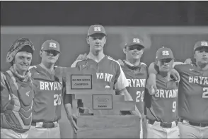  ?? RICK NATION/SPECIAL to The Saline Courier ?? Bryant senior Jackson Parker holds up the Big Red Trophy with his team after Friday’s 4-2 win over rival Benton in the Big Red Series in Benton. Parker was named the MVP of the game after his gamewinnin­g hit.