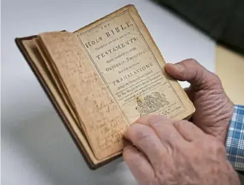  ?? Star Tribune ?? Phil Handy had a pre-Revolution­ary War Bible in need of repair.