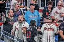  ?? AP PHOTO/BRYNN ANDERSON ?? Atlanta Braves fans react during the team’s home game against the Philadelph­ia Phillies in the opener of their National League Division Series on Oct. 7, 2023.