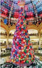  ??  ?? Giant Christmas tree stands in the Galeries Lafayette department store in Paris, France