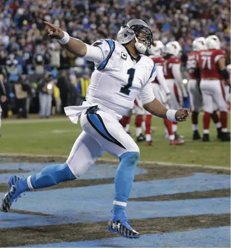  ?? CHUCK BURTON/THE ASSOCIATED PRESS ?? Panthers quarterbac­k Cam Newton celebrates a touchdown run against the Cardinals during the first half on Sunday in Charlotte, N.C.