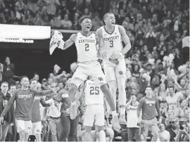  ?? MARK ZEROF/USA TODAY SPORTS ?? Guards Ashton Hagans (2) and Keldon Johnson (3) celebrate a win by Kentucky, which is 23-4 overall.