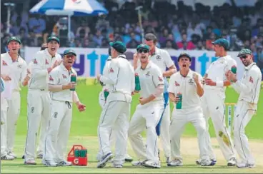  ?? BCCI PICS ?? Australia players celebrate the wicket of Virat Kohli on the third day of the second Test at Bengaluru.