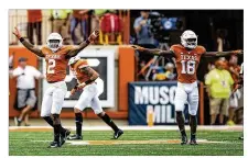  ?? NICK WAGNER / AMERICAN-STATESMAN ?? Texas defensive backs Kris Boyd (left) and Davante Davis signal no good after TCU missed a field goal. Boyd broke up two passes in the end zone Saturday in Austin.