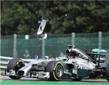  ?? ?? Error of judgement A piece of wing flies over Nico Rosberg’s car after a collision with Mercedes teammate Lewis Hamilton at the Spa- Francorcha­mps circuit in Spa late lastmonth.
AFP