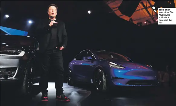  ?? AFP ?? Tesla chief executive Elon Musk with a Model Y compact 4x4