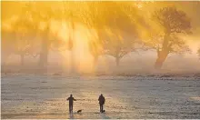  ??  ?? Dog walkers on a frosty morning: it’s not the same when the worst natural hazard is an unusually big puddle