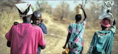  ?? PICTURE: AP ?? People walk for hours to reach a food distributi­on site in Malualkuel, in the Northern Bahr el Ghazal region of South Sudan. Two months after a famine was declared in two counties amid civil war, hunger has become more widespread than expected, aid...