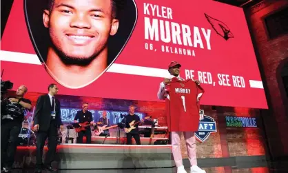  ??  ?? Kyler Murray poses with his Cardinals jersey after being picked as the No1 overall pick. Photograph: Christophe­r Hanewincke­l/USA Today Sports