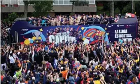  ?? Spanish title. Photograph: Josep Lago/AFP/Getty Images ?? ‘What matters now is to celebrate’ – Barcelona parade through the city after securing the