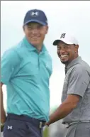 ?? AFP FILE ?? Tiger Woods and Jordan Spieth share a light moment on the practice range during the Hero World Challenge at Nassau, Bahamas, on Dec 3.