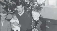  ??  ?? A Christmas photo of Peter Sharman with his daughter Carol in his arms.