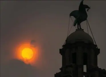  ??  ?? Bird of ill omen? One of the famous statues atop the Liver Building in Liverpool