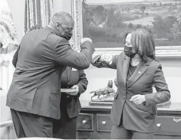  ?? DOUG MILLS/THE NEW YORK TIMES ?? Defense Secretary Lloyd Austin, a retired four-star Army general, elbow-bumps Vice President Kamala Harris during his ceremonial swearing-in Monday in the Roosevelt Room of the White House.