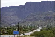  ?? MATT YORK — THE ASSOCIATED PRESS ?? Apache Leap Mountain hovers over Superior, Ariz., on June 9. The historic mining town is the subject of a tug of war between locals who want a copper mine developed nearby and Native American groups who say the land needed for mining is sacred and should be protected.