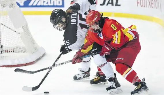  ?? ATSUSHI TOMURA/GETTY IMAGES/FILES ?? Di Deng, right, and China’s national women’s hockey team are hoping to give the country something to cheer for at the 2022 Winter Games in Beijing.