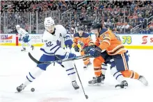  ?? CODIE MCLACHLAN/GETTY IMAGES ?? Matthew Benning, of the Edmonton Oilers, defends against Toronto Maple Leafs’ centre Tyler Bozak at Rogers Place, on Nov. 30, in Edmonton.