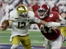  ?? Michael Ainsworth The Associated Press ?? Notre Dame quarterbac­k Ian Book is sacked by Alabama’s Byron Young in the Crimson Tide’s 31-14 win in the Rose Bowl.