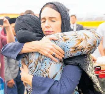  ??  ?? Jacinda Ardern hugs a mosquegoer at the Kilbirnie Mosque.