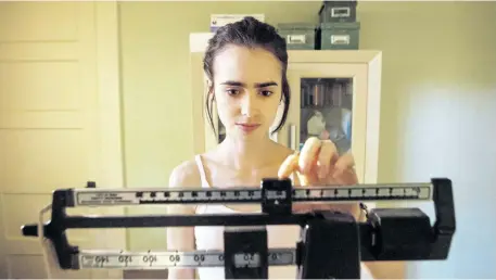  ??  ?? This image shows Lily Collins in a scene from the new Netflix series To The Bone. Several eating disorder organizati­ons around the world are sounding the alarm over the show which features a woman struggling with anorexia.