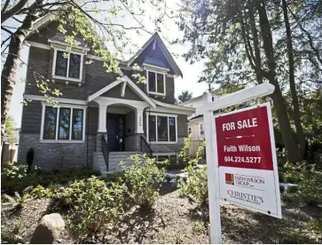  ?? — Bloomberg ?? Price hit: A “For Sale” sign is displayed outside a home in Canada. Average house prices are expected to decline by 9% to 18% over the next 12 months there.