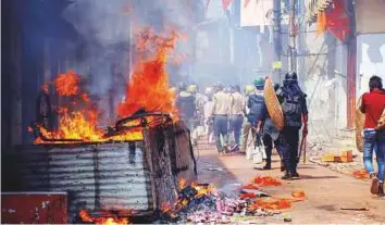  ?? PTI ?? ■ Police personnel patrol Raniganj in West Bengal’s Burdwan district after clashes and incidents of arson over a religious procession on Monday.