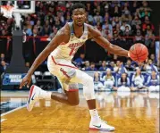  ?? KEVIN C. COX / GETTY IMAGES ?? Deandre Ayton is 19 and already a massive man, yet he blocked only 66 shots in 35 games and doesn’t seem to possess real defensive instincts.