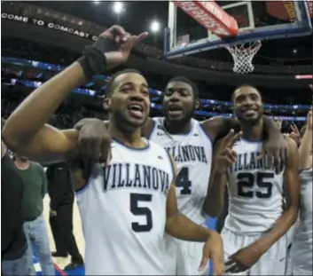  ?? THE ASSOCIATED PRESS FILE ?? Villanova’s Eric Paschall, center, celebratin­g a win over Georgetown last season with Phil Booth, left, and Mikal Bridges, is now a co-captain for the Wildcats as they prepare to open another season.