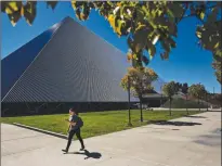  ?? Los Angeles Times/tns ?? A student passes by The Walter Pyramid at Cal State Long Beach, where the campus has gone to online only classes on Tuesday, March 11.