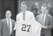  ?? WILLIE J. ALLEN — ASSOCIATED PRESS ?? Giancarlo Stanton, center, is flanked by Yankees general manager Brian Cashman, left, and manager Aaron Boone on Monday after Stanton’s trade from Miami was finalized.