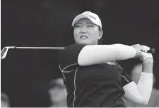  ?? GEOFF CADDICK/GETTY IMAGES ?? South Korea’s Mirim Lee hits a tee shot during action Friday at the Women’s British Open Golf Championsh­ip at Woburn Golf Club in Woburn, England. Lee followed up a 62 with 71 to lead the tournament by a stroke at the midway point.
