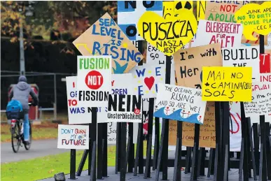  ?? PATRIK STOLLARZ/AFP/GETTY IMAGES ?? Slogans are posted as part of an installati­on in Bonn during COP23. To claim climate leadership, Prime Minister Justin Trudeau must reject new fossil fuel projects and reaffirm Canada’s commitment on climate change, writes Leehi Yona.