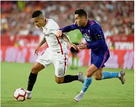  ?? — AFP ?? Back off: Sevilla defender Guilherme Arana (left) vying for the ball with Celta Vigo defender Hugo Mallo during the La Liga match at the Ramon Sanchez Pizjuan Stadium on Sunday.