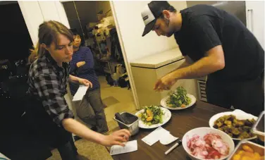  ?? Photos by Eric Luse / The Chronicle 2009 ?? Waitress Sarah Coemen places an order while guest chef Leif Hedendal puts together salads at Mission Street Food in 2009. The runaway hit restaurant was largely ignored by mainstream media at the time.