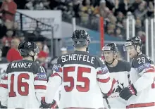  ?? PETR DAVID JOSEK/THE ASSOCIATED PRESS ?? Canada’s Nate Mackinnon, right, with teammates Tyson Barrie, 2nd right, Mark Scheifele, 2nd left, Mitch Marner, left, after scoring a goal against Slovenia during the world hockey championsh­ip on Sunday. Canada defeated Slovenia 7-2.