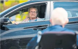  ?? STEVE MCKINLEY TORONTO STAR ?? Marilyn Petrie smiles at her husband, Wayne, during an outdoor visit Monday at Glen Haven Manor long-term-care facility in New Glasgow, N.S. The couple hadn’t seen each other in months.