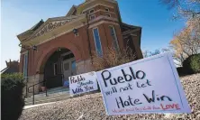  ?? Christian Murdock / Colorado Springs Gazette ?? Signs expressing support for the Jewish community stand outside the Temple Emanuel in Pueblo, Colo., in July.