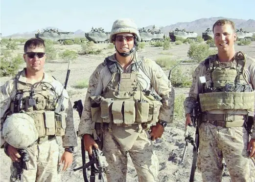  ?? PROVIDED ?? Marine Maj. Thomas Schueman (right), a Chicago native, in Afghanista­n. He’s trying to get an interprete­r who he says helped save him and others out of that country and, with his family, to the United States. At left is Lt. William Donnelly, a friend of Schueman who was killed in action. Center is First Lt. Cameron West.