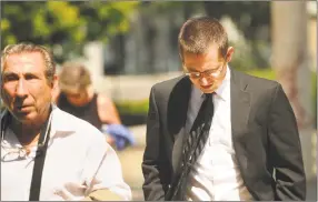  ?? Brian A. Pounds / Hearst Connecticu­t Media ?? George Garofano, right, of North Branford, walks into Federal District Court in Bridgeport Wednesday for sentencing in the high-profile hacking case. Nude photos of celebritie­s such as Jennifer Lawrence, Kirsten Dunst and soccer player Hope Solo were stolen from personal accounts and posted online in 2014.