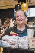  ?? BETH AUDET TORSTAR ?? Amid the mad rush of the Ontario Street McDonald’s grand re-opening and50th anniversar­y celebratio­n, manager Sabrina Frechette carries a tray of 50-cent hamburgers out to a group of hungry customers.
