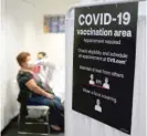  ?? AP ?? A patient gets a COVID-19 vaccine March 1 at a CVS Pharmacy in Los Angeles.