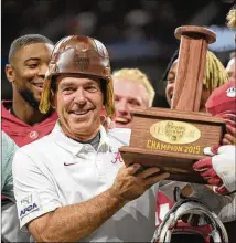  ?? VASHA HUNT VIA ABELL IMAGES FOR CHICK-FIL-A KICKOFF ?? Alabama coach Nick Saban tries on the Old Leather Helmet during the Chick-fil-a Kickoff in 2019. Last year, three games were canceled because of the pandemic.