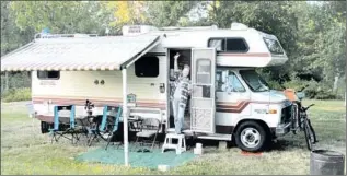  ?? Ralph Reed Special to The Times ?? THE AUTHOR f lashes a peace sign from the doorway of her RV in Shelton, Wash.