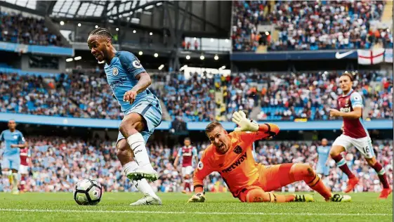  ??  ?? No obstacle: Raheem sterling goes past West Ham goalkeeper Adrian to score Manchester City’s third goal at the Etihad on sunday. — Reuters